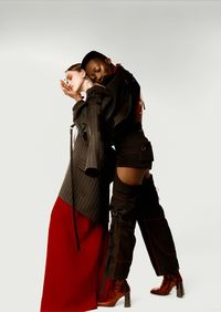Young couple standing against white background