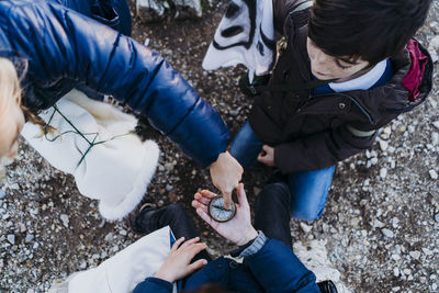 Group of children holding a compass