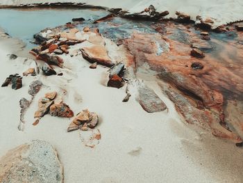 Stream of water with rocks flowing through the sand