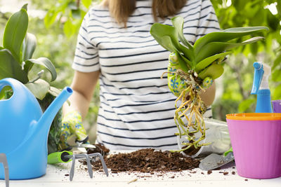 Midsection of woman holding food on table