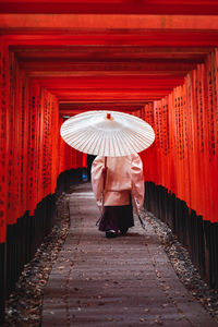 Rear view of boy walking in temple