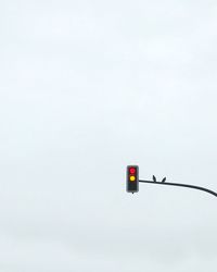 Low angle view of road sign against sky