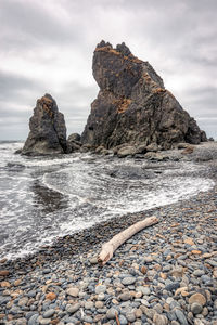 Rocks on beach against sky