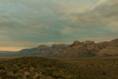 Scenic view of mountains against cloudy sky