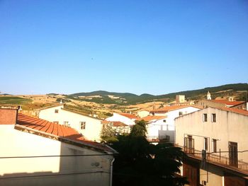 Residential buildings against blue sky