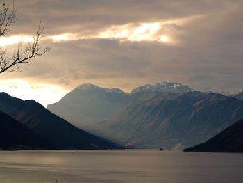 Scenic view of mountains and lake against sky during sunset