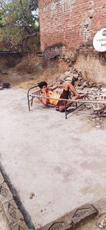 People relaxing on wall