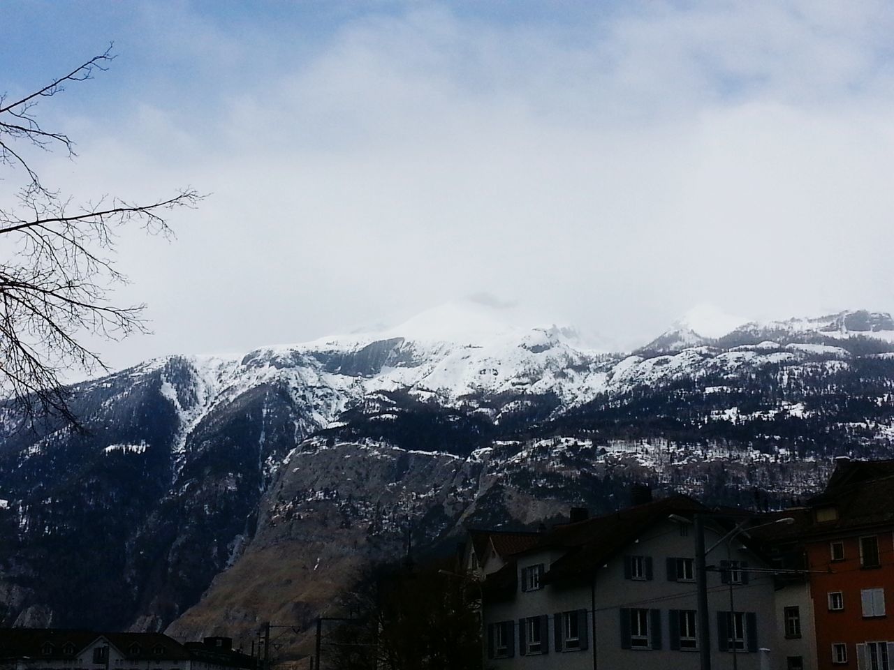 building exterior, mountain, winter, architecture, built structure, snow, cold temperature, sky, weather, season, mountain range, residential structure, cloud - sky, tree, house, residential building, residential district, city, nature, snowcapped mountain