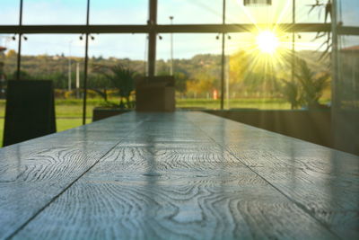 Surface level of table against sky during sunset