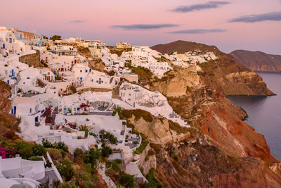 High angle view of townscape by sea against sky