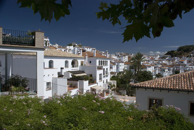 Buildings in town against sky