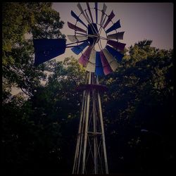 Low angle view of traditional windmill against sky