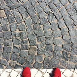 Low section of person standing on cobblestone