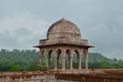 Low angle view of historical building against cloudy sky