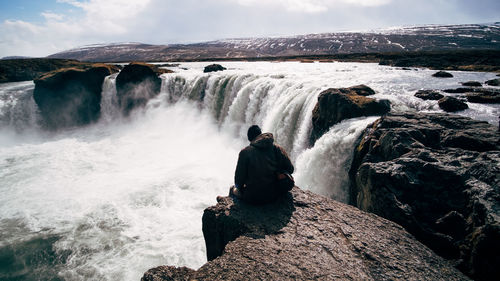 Rear view of waterfall against rocks