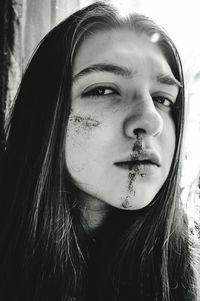 Close-up portrait of young woman with wound