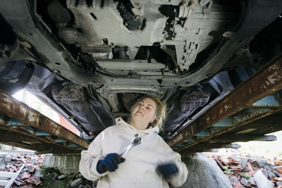 Woman repairing car