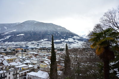 Buildings in city against sky during winter