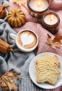Cup of coffee with seasonal autumn spices, cookies and fall decor. traditional coffee drink 