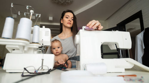 Portrait of smiling young woman sitting on table