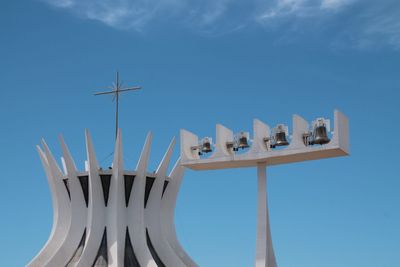 Low angle view of cathedral with bells against blue sky