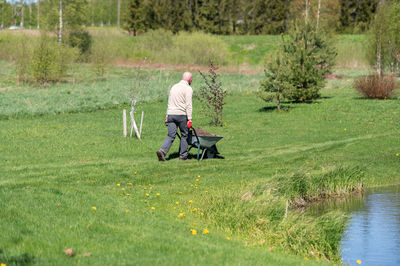 Rear view of woman walking on field