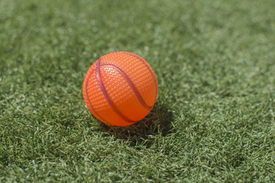 Close-up of orange ball on grass