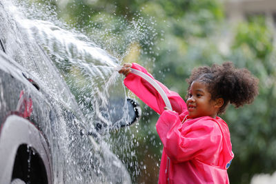 Side view of girl looking at water