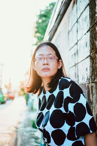 Portrait of beautiful young woman standing in city