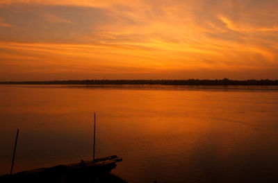 Scenic view of sea against orange sky