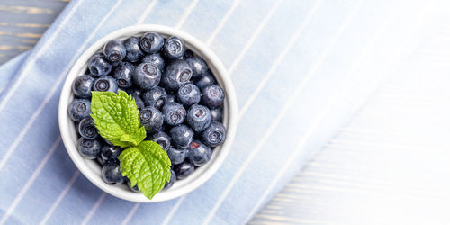High angle view of berry fruits in plate on table