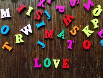 Directly above shot of colorful text on wooden table