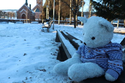 Close-up of toy on snow covered park during winter