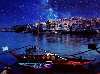 Boats in calm sea at night