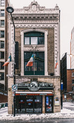 Road sign on street against buildings in city