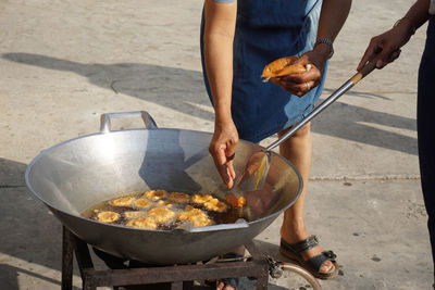 Midsection of man preparing food