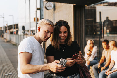 Young friends looking at cell phones