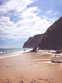 Scenic view of sea against cloudy sky