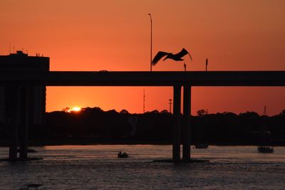 Silhouette of built structure at sunset