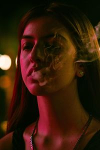 Close-up portrait of young woman looking away