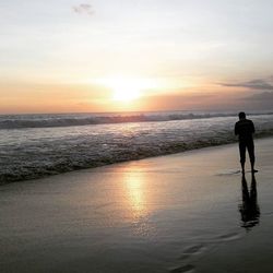 Silhouette of woman standing on beach