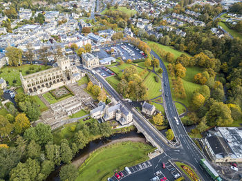 High angle view of road amidst trees and buildings in city