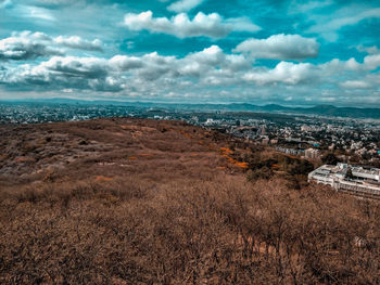 Aerial view of sea and buildings against sky