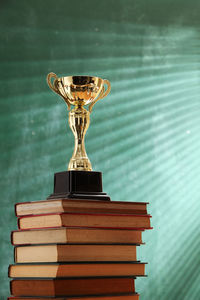 Close-up of trophy on books