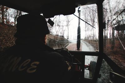 Rear view of man seen through window