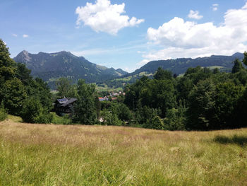 Scenic view of mountains against cloudy sky