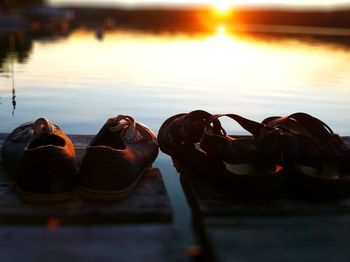 Boats in river at sunset