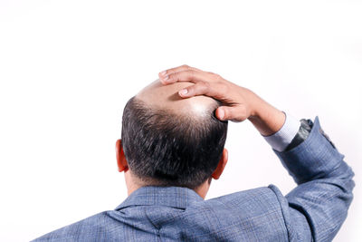 Rear view of man against white background