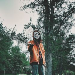 Low angle view of woman standing on tree