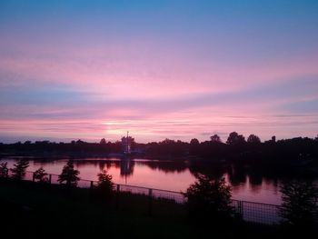 Scenic view of lake against romantic sky at sunset